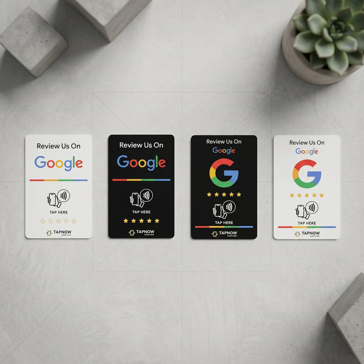 Four TapNow Google review cards in black and white designs with NFC tap icon and QR code, displayed on a marble surface